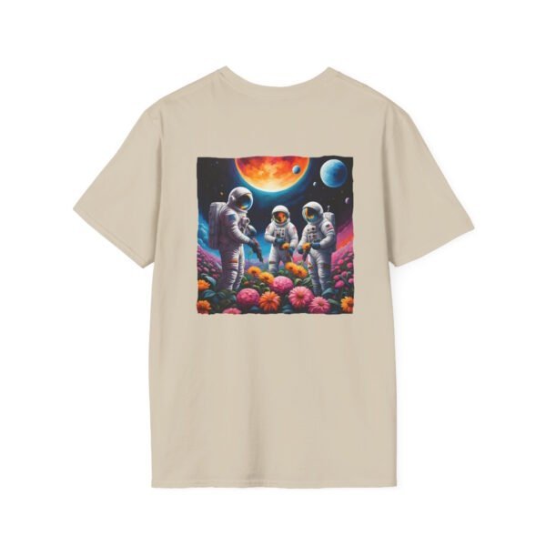 A sand colored T-shirt featuring a vibrant graphic of three astronauts in spacesuits watering colorful flowers under a celestial sky planets.