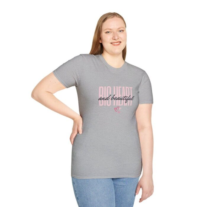 A beautiful woman wearing a sport grey Big Baby Gorilla Bear t-shirt that has the words "Big Heart and beautiful" written out in pink and black, with some pink hearts beneath.