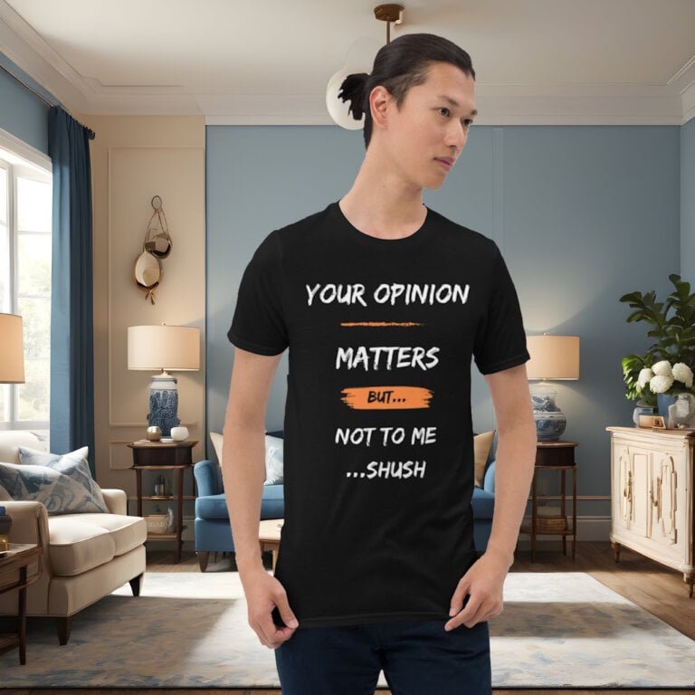 A handsome male model in an elegant room, wearing a black "Your opinion matters but...not to me" t-shirt with white letters and orange highlights.