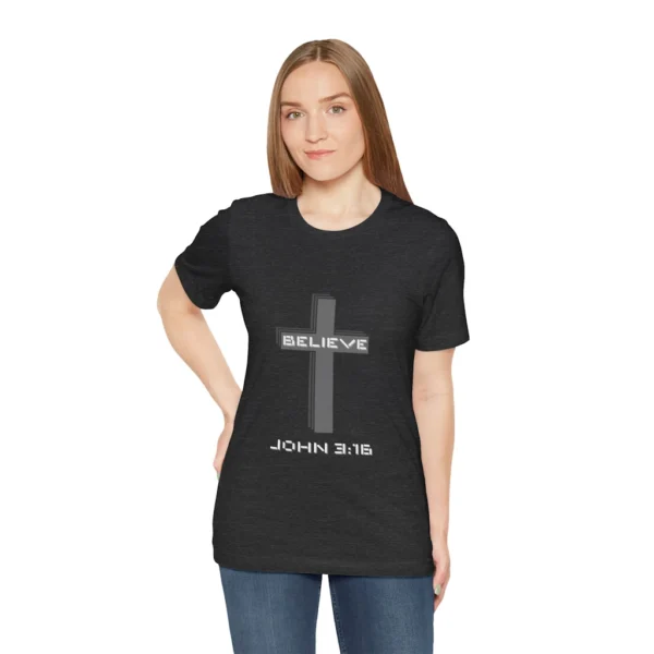 A female model wearing a Dark Heather colored "Believe 3:16", with a 3D stacked cross graphic and the words "Believe" and "John 3:16" on the front.