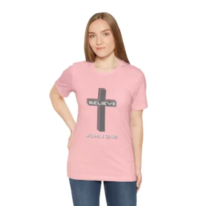 A female model wearing a Pink colored "Believe 3:16", with a 3D stacked cross graphic and the words "Believe" and "John 3:16" on the front.