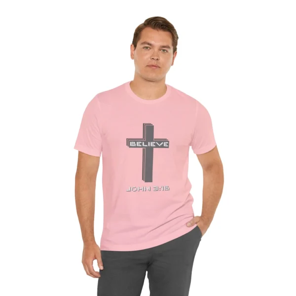 A male model wearing a Pink colored "Believe 3:16", with a 3D stacked cross graphic and the words "Believe" and "John 3:16" on the front.