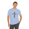 A male model wearing a Soft Blue colored "Believe 3:16", with a 3D stacked cross graphic and the words "Believe" and "John 3:16" on the front.