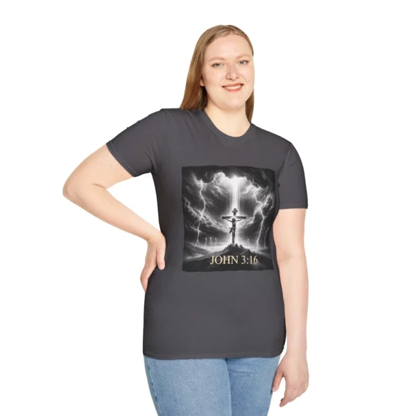 Charcoal Colored "Cross John 3:16" Faith Collection T-shirt on a female model. Has a picture of Jesus on the Cross with a storm and a lot of lightening. in the background.