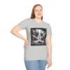 Ice Grey Colored "Cross John 3:16" Faith Collection T-shirt on a female model. Has a picture of Jesus on the Cross with a storm and a lot of lightening. in the background.