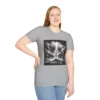 Sport Grey Colored "Cross John 3:16" Faith Collection T-shirt on a female model. Has a picture of Jesus on the Cross with a storm and a lot of lightening. in the background.