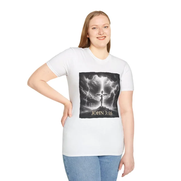 White Colored "Cross John 3:16" Faith Collection T-shirt on a female model. Has a picture of Jesus on the Cross with a storm and a lot of lightening. in the background.