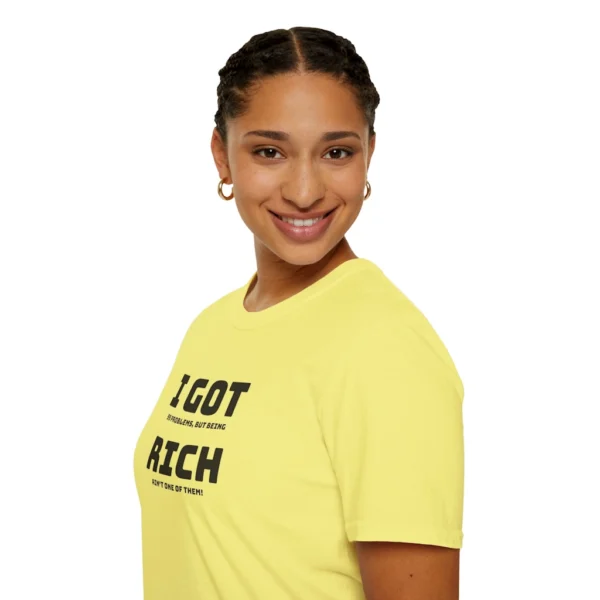 Female model wearing an Cornsilk colored "I Got 99 Problems, But Being Rich Ain't One of Them!" T-shirt, left front viewpoint.