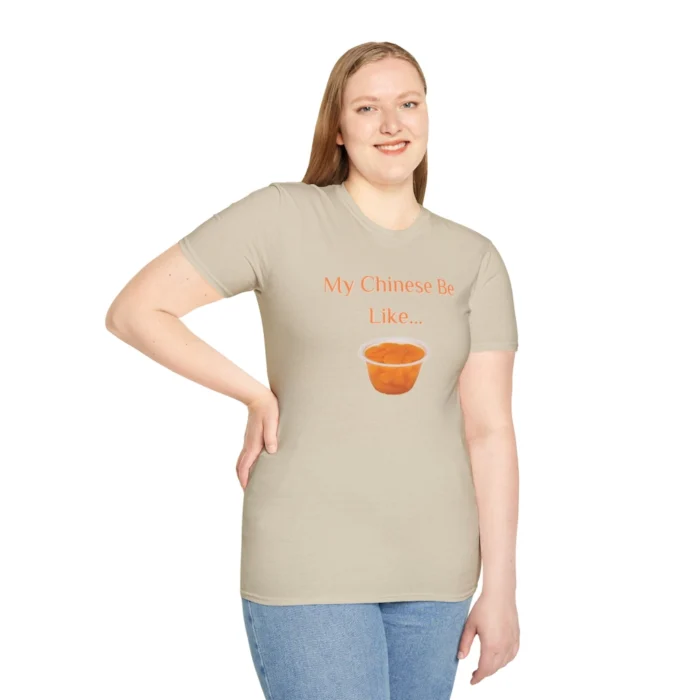 A model wearing a sand colored T-shirt with the words "My Chinese Be Like..." and an image of Mandarin Oranges.