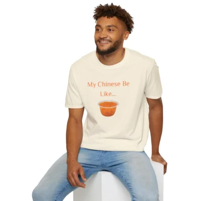 Male model wearing a natural colored graphic tee, with a picture of Mandarin Oranges and the writing "My Chinese Be Like...".