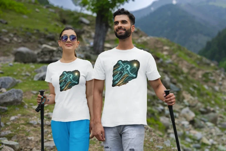 A male and female duo hiking and showing the front of the "Astronaut Got To The Light" White Tee. Showcasing an astronaut outline in blue and yellow neon colors, reaching for an orb of light.