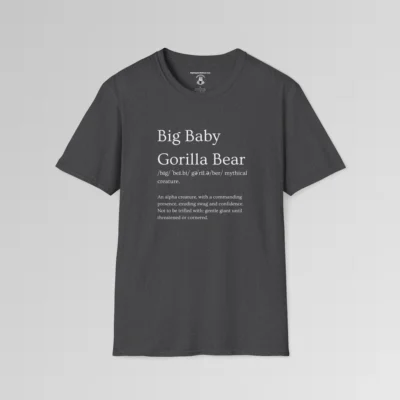 Dark heather colored t-shirt mockup with the words "Big Baby Gorilla Bear" on the front, in the appearance of a word in a dictionary, including pronunciation beneath the main words and a slash saying "Mythical creature. The text beneath says "An alpha creature, with a commanding presence, exuding swag and confidence. Not to be trifled with; gentle giant until threatened oir cornered."