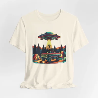 Natural colored t-shirt mockup of a camping scene, with a 1980 style pick-up truck, tents, and an alien space ship in the background, abducting a Big Foot looking creature from out of a pine forest. Colors are red, orange, blue, and yellow.
