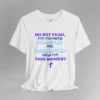 An ash colored tee with the words "Do Not Fear, For You Were Fearfully and Wonderfully Made For This Moment" in varying fonts and colors (purple, deep blue, and light aqua blue). There is a graphic, artistic purple cross beneath the words.