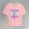 A pink colored tee with the words "Do Not Fear, For You Were Fearfully and Wonderfully Made For This Moment" in varying fonts and colors (purple, deep blue, and light aqua blue). There is a graphic, artistic purple cross beneath the words.