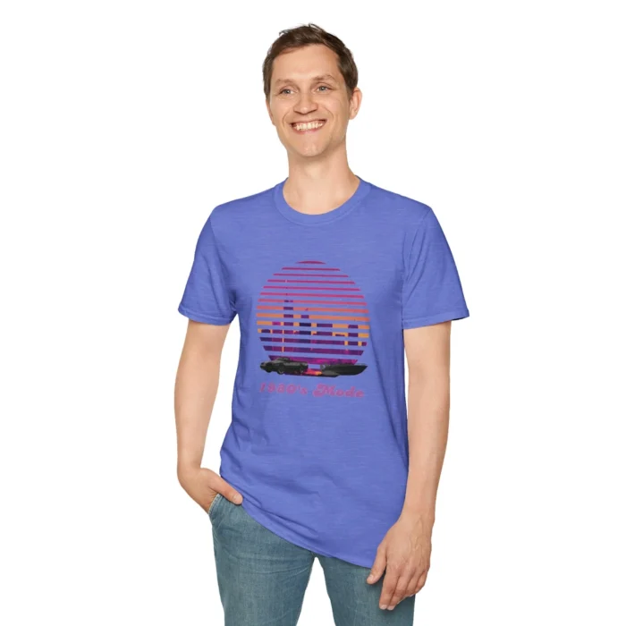 Attractive male wearing the Heather Royal colored "Miami 1980's Mode" tee, showcasing a city at sunset with a vertical blind effect, and a convertible car and speed boat at the bottom of the image, and "1980's Mode" written beneath the image in a retro font style.