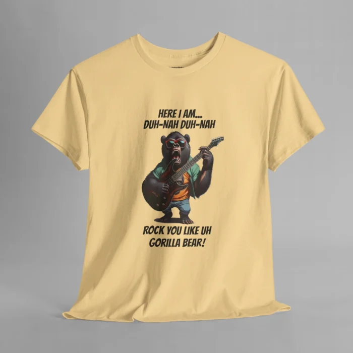 A yellow haze colored t-shirt mockup of a gorilla bear creature, dressed a green button up, an orange undershirt graphic tee, and blue jean shorts and shades, holding an electric guitar. The text on the shirt says "Here I am...Duh-Nah Duh-Nah Rock you like a Gorilla Bear"