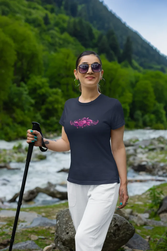 The Navy Colored "Tribal Pink-Purple Flowers Woman's Tee", as shown by an attractive female...The shirt has a tribal design with pink and purple hued flowers in the center.