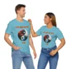 Male and Female duo showcasing the "I Got That Yin-Yang Pow!" BBGB t-shirt, with a yin-yang that looks like a globe and vibrant trees growing on the outskirts of the yin-yang. Turquoise Colored.