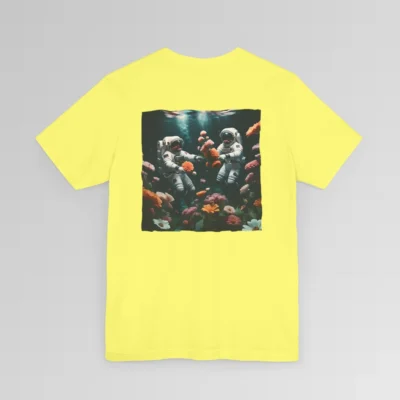 A yellow shirt with a surreal image on the backside of a tee of two astronauts in space suits swimming in the ocean, with colorful coral, purple, white, peach, and yellow flowers. One astronaut is holding a flower.