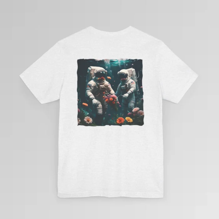 An ash shirt with a surreal image on the backside of a tee of two astronauts in space suits walking on an ocean floor, with colorful coral, purple, white, peach, and yellow flowers.