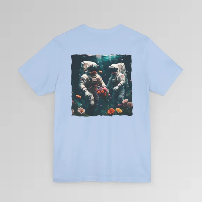 A baby blue shirt with a surreal image on the backside of a tee of two astronauts in space suits walking on an ocean floor, with colorful coral, purple, white, peach, and yellow flowers.