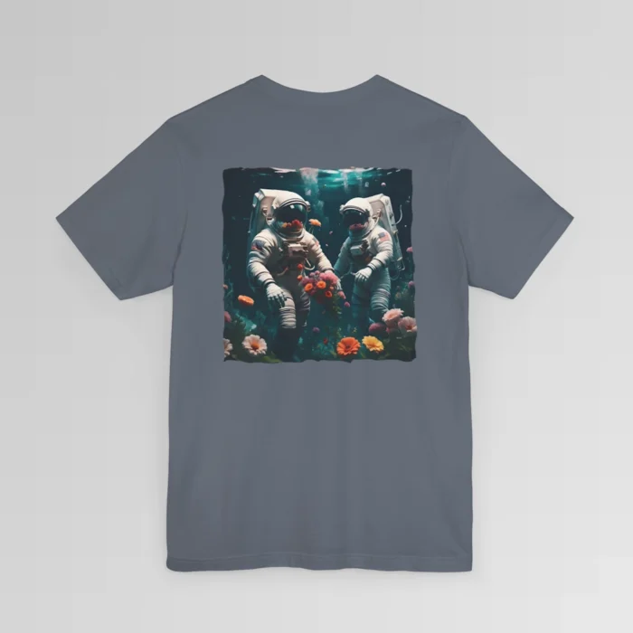 A steel blue shirt with a surreal image on the backside of a tee of two astronauts in space suits walking on an ocean floor, with colorful coral, purple, white, peach, and yellow flowers.