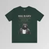 A forest green t-shirt mockup with our iconic grizzly bear and gorilla hybrid, wearing a leather jacket, cross necklace, and shades. The background of the shirt has a grid and some confetti. The words above the image are "Big Baby Gorilla Bear in two fonts, with a decorative ribbon separating the words from the mascot image. Retro look with tan, black, grey, and white colors.