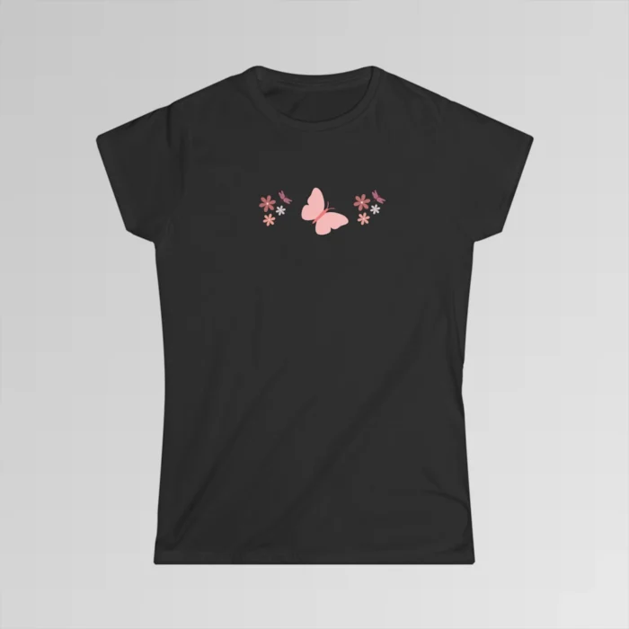 A black colored shirt with a pink butterfly with a coral-colored body in the center, and pink, white, and blush colored flowers, and blush colored dragonflies...in a pattern going vertically across the tee.