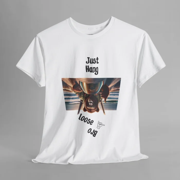 A white colored graphic tee with one of our iconic bear-gorilla hybrid creatures riding on top of a fighter over a beach. The image is turned upside down, and in the shape of an upside down trapezoid. Above the image is writing that says " Just Hang", and beneath the image it says "Loose Bro" at an angle, and with a hang-loose hand gesture clip art.