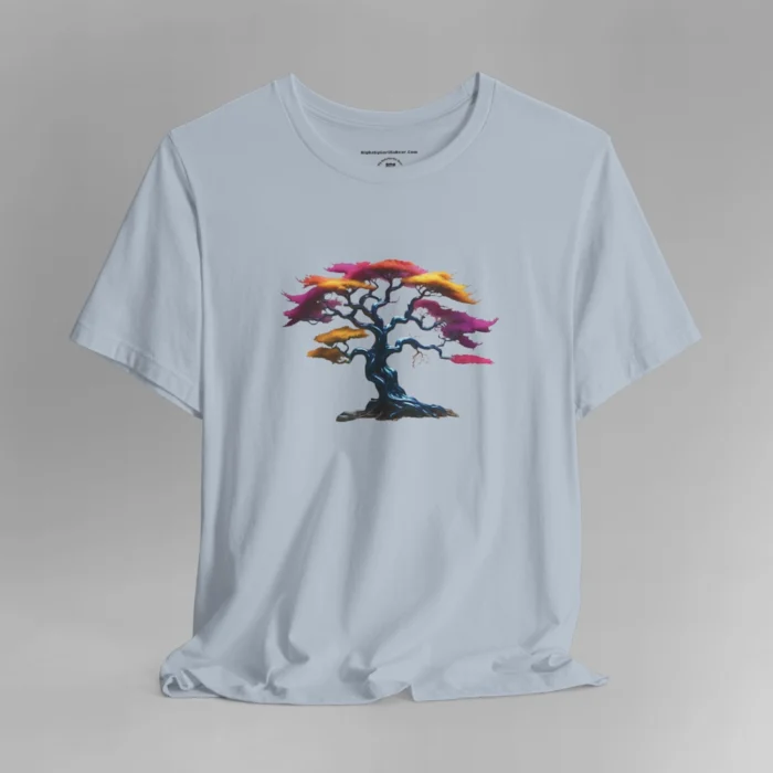 A light blue t-shirt with a graphic image of a blued liquid metal tree, with leaves of orange, pink, coral, and magenta on the front of the t-shirt.