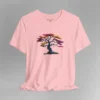 A pink t-shirt with a graphic image of a blued liquid metal tree, with leaves of orange, pink, coral, and magenta on the front of the t-shirt.