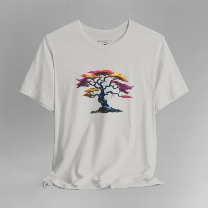 A silver t-shirt with a graphic image of a blued liquid metal tree, with leaves of orange, pink, coral, and magenta on the front of the t-shirt.