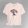 A soft pink t-shirt with a graphic image of a blued liquid metal tree, with leaves of orange, pink, coral, and magenta on the front of the t-shirt.