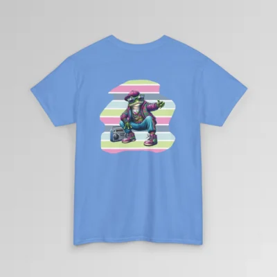 A carolina blue colored t-shirt mockup with a 1980's styled anthropomorphic frog, wearing pants, shoes, hat, and jacket with shades. The frog is kneeling by a beatbox, and there is a non-symmetrical backdrop with varied colored lines in a ship-lap pattern. Shirt graphic colors are pinks, greens, blues, purples, steel blues, light blues, and white and cream colors.