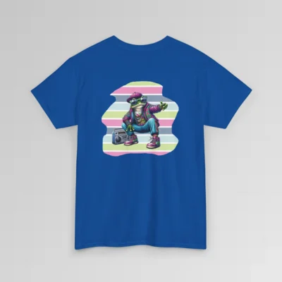 A royal blue colored t-shirt mockup with a 1980's styled anthropomorphic frog, wearing pants, shoes, hat, and jacket with shades. The frog is kneeling by a beatbox, and there is a non-symmetrical backdrop with varied colored lines in a ship-lap pattern. Shirt graphic colors are pinks, greens, blues, purples, steel blues, light blues, and white and cream colors.