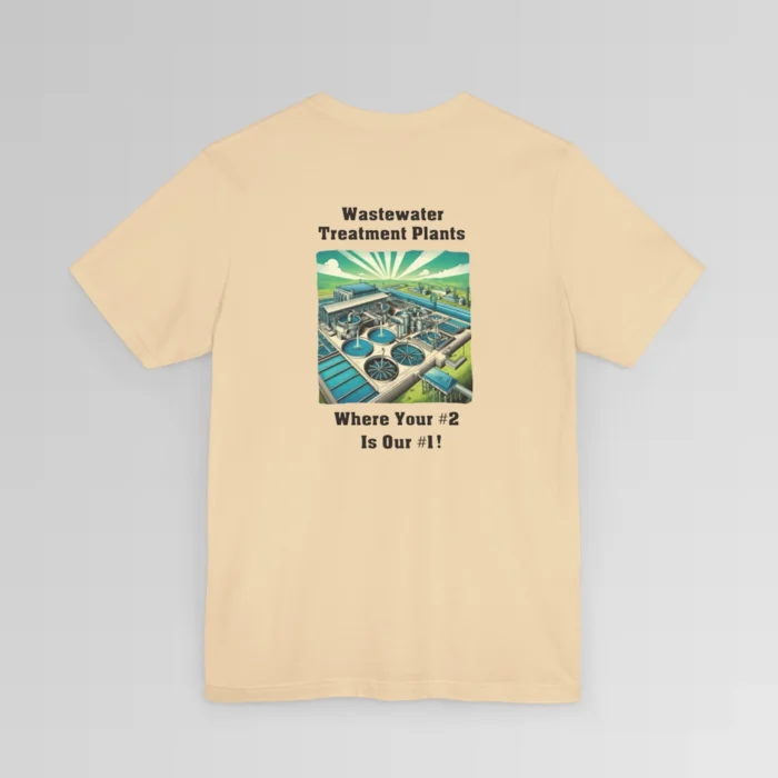 An soft cream colored shirt with the words "Wastewater Treatment Plant" above and image of a waste water treatment plant sketch (with green, silver, blue, and white colors). Beneath the image are the words "Where Your #2 Is Our #1". Graphic is on the backside of shirt.