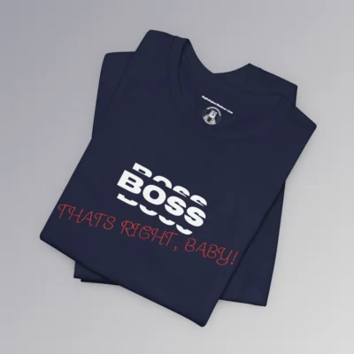 A folded Tee mockup with the word "BOSS" in white, and a rectangle that matches the shirt color around the word. Beneath the word, in slightly smaller white font is a partial view of the word "BOSS", on both bottom and top of the original word, all in a boxy-ish font. Beneath this, in a red handwriting font, is the phrase "Thats Right, Baby!". - Navy colored.