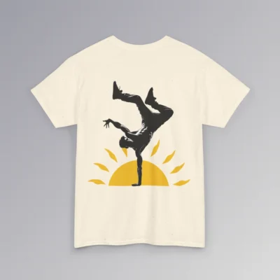 The BigBabyGorillaBear.Com "Kiss The Sun Breakdancing", natural colored, t-shirt, with a male model showing the backside of the shirt with a break-dancer silhouette doing a handstand with a sunshine graphic behind him.