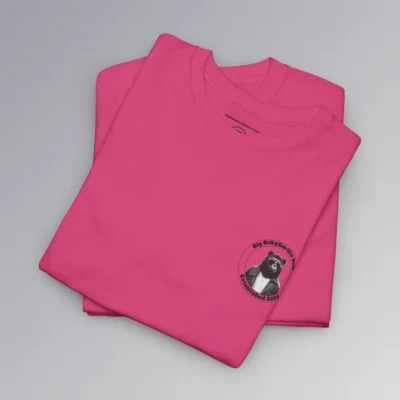 Frontside of a folded heliconia colored tee, with the circular Big Baby gorilla Bear 2024 logo, with two circles, and on the inside, the image of our iconic mascot in leather jacket and shades. Between the inner circles of the logo, on the top is the brand name, and on the bottom it says "established 2024". The "Kiss The Sun Breakdancing" T-shirt.