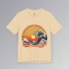 The frontside of a soft cream colored t-shirt with an oriental feel, and a blue wave white-capping, with a sunset in the background. The wave looks as if it touches the sun. There are mountains, clouds, and gentle waves, with hues of orange, red, and yellows.