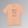 Heather peach colored t-shirt with blue, red, orange, and purple coneflower-like flowers, with green and mauve colored stems. In a handwriting font, is says "Wildflowers grow..." above the flowers, and "in wild places!" beneath the flowers.