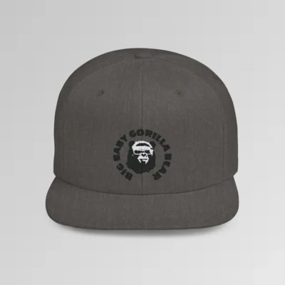 A mockup of the front of the "BBGB Flat Bill Snapback Cap", with "Big Baby Gorilla Bear" embroidered in a circular font pattern surrounding the Big Baby Gorilla Bear Mascot embroidered on a dark heather cap.