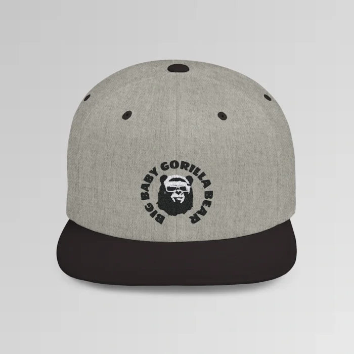 A mockup of the front of the "BBGB Flat Bill Snapback Cap", with "Big Baby Gorilla Bear" embroidered in a circular font pattern surrounding the Big Baby Gorilla Bear Mascot embroidered on a heather black cap.