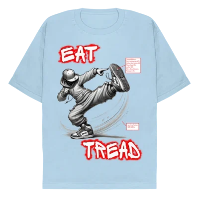 A light blue tee with the words "Eat" and "Tread" in a graffiti style font, above and below (respectively) an image of a character throwing a side kick, in streetwear clothing. There are two info boxes; one with the chemical makeup of the sole of the shoes, and one with the force in lbs. of the kick. (Front).