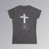 The front of a t-shirt with 3D text which states "Christ Is My Firm Foundation", from a slightly left perspective, in the shape of a simple house, with an old, wooden cross in the background. Color: Charcoal. Her Style.