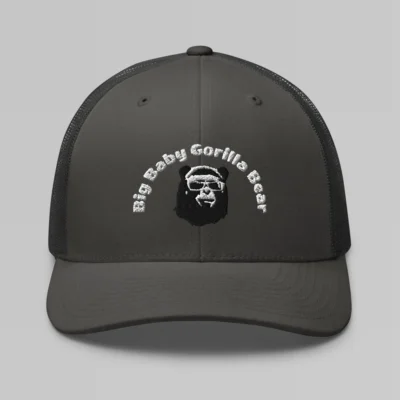 Front side view of a Charcoal mesh trucker cap, with the Big Baby Gorilla Bear mascot's face and the Big Baby Gorilla Bear Name Embroidered in black and white on the front of the cap.