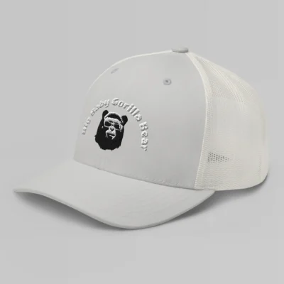 Left side view of a Silver mesh trucker cap, with the Big Baby Gorilla Bear mascot's face and the Big Baby Gorilla Bear Name Embroidered in black and white on the front of the cap.