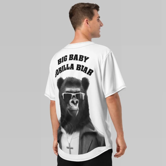 A male model, showcasing the backside of the BBGB Recycled Baseball Jersey from BigBabyGorillaBear.Com (White jersey). Has the words "Big Baby Gorilla Bear", stacked, and in curved font, with a super-imposed image of the Big Baby Gorilla Bear mascot, wearing sunglasses, leather jacket, and a Cross necklace.