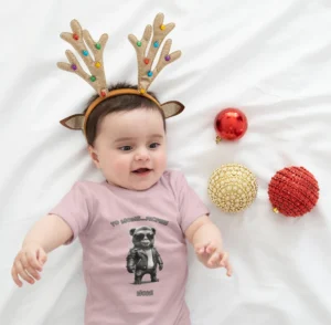 Cute baby wearing a reindeer headband, laying on a sheet, with Christmas bulbs, and wearing a Big Baby Gorilla Bear onesie with a toddler version of the Big Baby Gorilla Bear Mascot, and the words "Yo Moms...Pacifier! Now!"